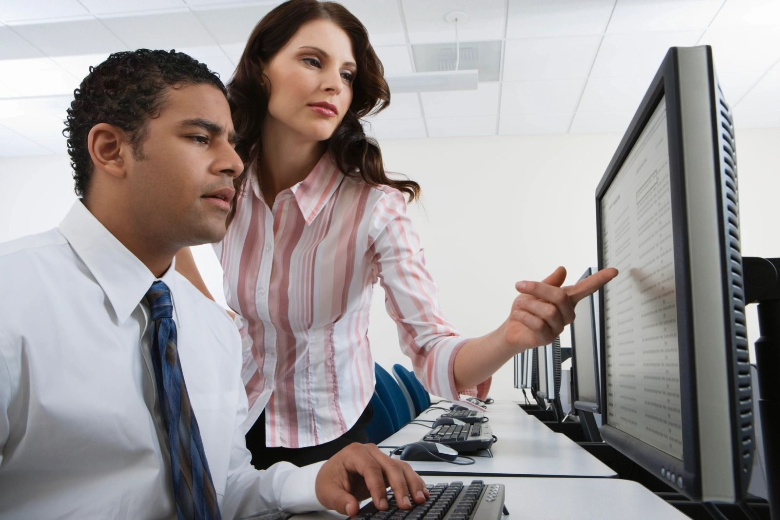 Technician helping a client at a computer.